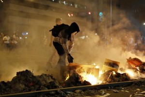 A supporter of opposition leader Leopoldo Lopez sets fire to a barricade during a protest against Nicolas Maduro's government in Caracas