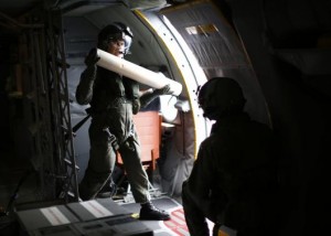  Crew member Garrick Anderson prepares to throw a GPS tracking buoy into the Southern Indian Ocean to mark the position of a solid object in the water aboard a Royal New Zealand Air Force P-3K2 Orion aircraft searching for missing Malaysian Airlines flight MH370 over the southern Indian Ocean March 22, 2014. CREDIT: REUTERS/JASON REED