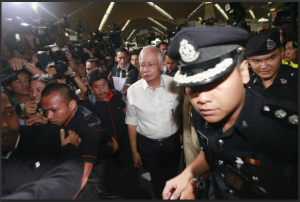 Malaysia's Prime Minister Najib Razak (C) arrives at the holding area for family and friends of passengers aboard missing Malaysia Airlines flight MH370, at Kuala Lumpur International Airport in Sepang March 8, 2014.  REUTERS/Samsul Said