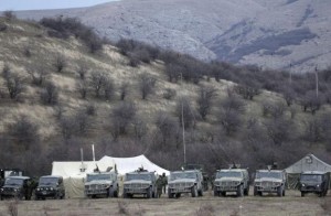  Military vehicles, believed to be property of Russian army, are seen near the territory of a Ukrainian military unit in the village of Perevalnoye outside Simferopol March 2, 2014.  CREDIT: REUTERS/VASILY FEDOSENKO