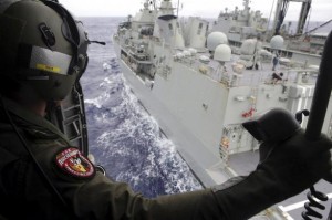 Leading Seaman Aircrewman Joel Young looks out from Tiger75, an S-70B-2 Seahawk helicopter, after it launched from the Australian Navy ship the HMAS Toowoomba as it continues the search in the southern Indian Ocean for the missing Malaysian Airlines flight MH370, in this picture released by the Australian Defence Force April 4, 2014.  REUTERS/Australian Defence Force/Handout via Reuters