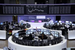  Traders are pictured at their desks in front of the DAX board at the Frankfurt stock exchange, July 1, 2014. Credit: Reuters/Remote/Thomas Peter 