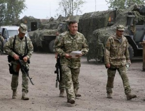 Newly-appointed Ukrainian Defence Minister Valery Heletey (C) walks with troops at a temporary base near the city of Slaviansk July 6, 2014. Credit: Reuters/Gleb Garanich