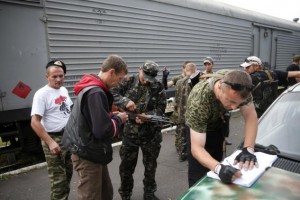 Armed pro-Russian separatists receive bullets as they gather near the train transporting the remains of victims from the crashed Malaysia Airlines Boeing 777 plane before its departure, with bags and suitcases of passengers seen in the foreground, from the railway station in the eastern Ukrainian town of Torez, in the Donetsk region July 21, 2014. Credit: Reuters/Maxim Zmeyev