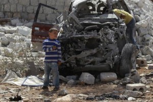  Boys inspect a vehicle which was damaged in what activists say was one of Tuesday's U.S. air strikes in Kfredrian, Idlib province September 24, 2014. Credit: Reuters/Ammar Abdullah