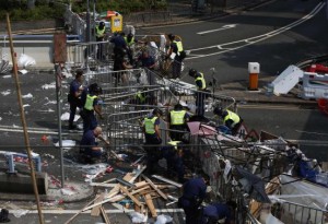 Police remove a barricade left by pro-democracy protesters on a main road leading to the financial Central district in Hong Kong October 14, 2014.   REUTERS/Bobby Yip