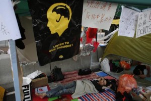 A pro-democracy protester sleeps under a make-shift shelter on a road during a blockade at the financial Central district in Hong Kong October 10, 2014. REUTERS/Bobby Yip