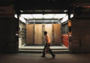 The entrance to a shopping arcade is reinforced with wooden panels, preventing possible damage during confrontations, as pro-democracy protesters continue to block a main road at Mongkok shopping district in Hong Kong, early October 8, 2014. Credit: Reuters/Liau Chung-ren