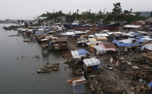 A view of temporary shelters for typhoon survivors that were constructed next to a ship that ran aground is pictured nearly 100 days after super Typhoon Haiyan devastated Tacloban city in central Philippines February 14, 2014.  REUTERS/Erik De Castro