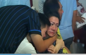 Relatives of  passengers of the missing Indonesian Air Asia airbus grieve after hearing confirmation on recovered debris and bodies from the missing plane. (Photo grabbed from Reuters video)