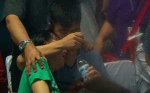 Families of passengers onboard missing AirAsia flight struggle to cope with their grief, after rescuers found wreckage and bodies in the sea off the coast of Borneo.  (Photo grabbed from Reuters video)