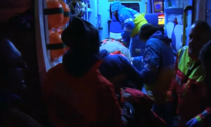 A rescued ferry passenger is placed inside an ambulance to be brought to a hospital in Italy's Brindisi.  (Photo grabbed from Reuters video)