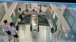 Photo grabbed from surveillance video where a woman is shown carrying her son before the escalator accident (Photo grabbed from video provided by China Central Television)