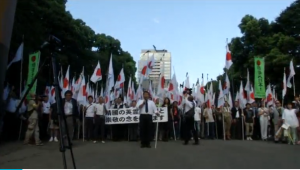 Japanese nationalists at Yasukuni war shrine carrying Japanese flags and shouting "Banzai".  (Photo grabbed from Reuters video)