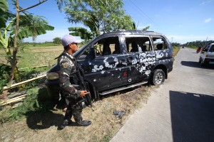 A Filipino soldier stands next to a vehicle damaged late February 16 by a roadside bomb along a highway in Datu Saudi Ampatuan town, Maguindanao province, in the southern island of Mindanao on February 17, 2016. Three civilians were killed in a roadside bomb explosion in a remote Philippine region where the army and Muslim rebels have engaged in sporadic fighting for days, police said February 17.  AFP PHOTO / Ferdinandh Cabrera / AFP / FERDINANDH CABRERA