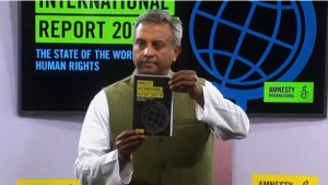 Amnesty International secretary-general Salil Shetty holding a copy of the annual annual State of the World's Human Rights report during a press conference. The international human rights body said that global rights are in jeopardy. (Photo courtesy: Reuters/Photo grabbed from Reuters video)