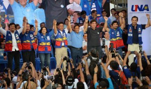 Philippine presidential candidate Jejomar Binay (4th R), who is leader of the opposition and current Philippine vice president, gestures onstage with his vice-presidential candidate Senator Gringo Honasan (3rd R), and senatorial line up led by boxing icon Manny Pacquiao (2nd R) raise their hands during their party's proclamation rally in Manila on February 9, 2016. A cliffhanger race to lead the Philippines began February 9 with the adopted daughter of a dead movie star and a tough-talking politician who claims to kill criminals among the top contenders. AFP PHOTO / TED ALJIBE / AFP / TED ALJIBE