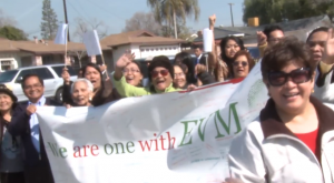 INC members who attended the house of worship dedication in Bakersfield, California hold a streamer where the words, "We are one with EVM" can be read. (Eagle News Service)