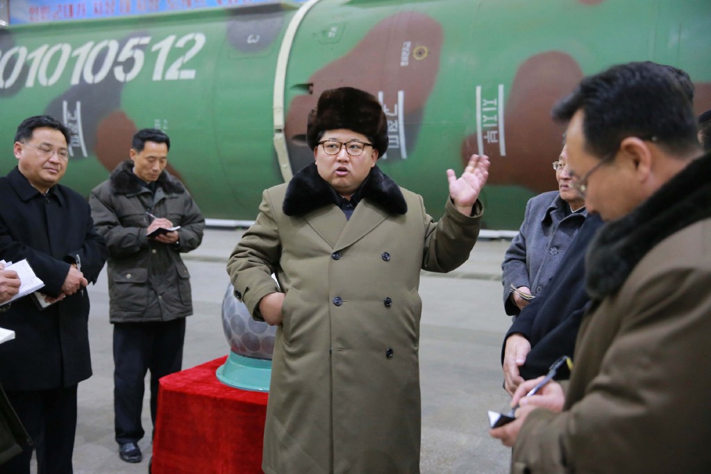 This undated picture released from North Korea's official Korean Central News Agency (KCNA) on March 9, 2016 shows North Korean leader Kim Jong-Un (C) meeting with the scientists and technicians in the field of researches into nuclear weapons and guiding the work for boosting the  nuclear arsenal at an undisclosed location. / AFP / KCNA / KCNA