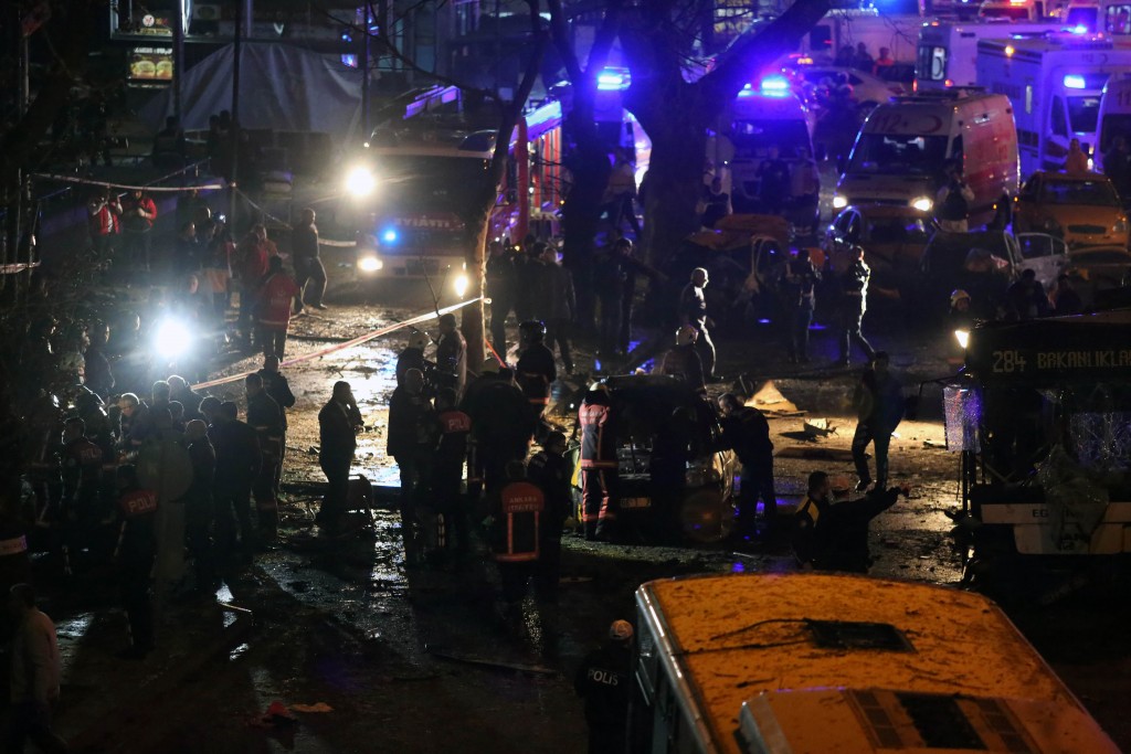 Police, firefighters and emergency services work at the site of a blast in Ankara on March 13, 2016.  A suicide car bomb ripped through a busy square in central Ankara on March 13, killing at least 27 people and wounding 75, officials said, the latest in a spate of deadly attacks to hit Turkey. The blast in Kizilay square is the second major attack in the heart of the Turkish capital in less than a month, after a suicide car bombing on February 17 targeting the military that killed 29 people, claimed by a dissident faction of the outlawed Kurdistan Workers' Party (PKK).  / AFP / ADEM ALTAN