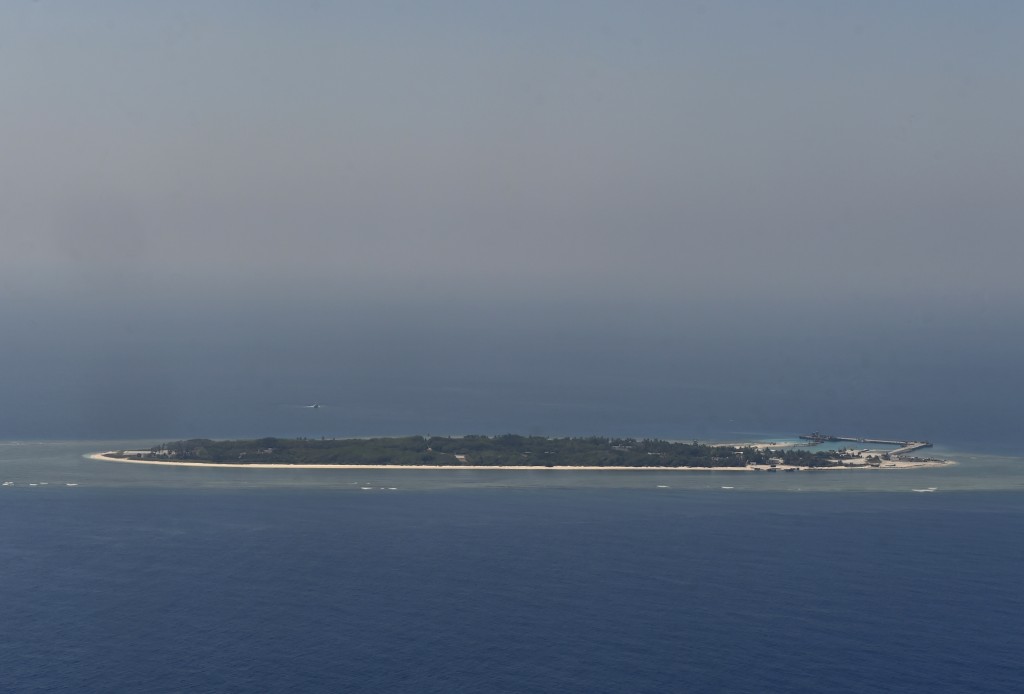 This aerial image taken from a C-130 transport plane shows a general view of Taiping island during a visit by journalists to the island, in the Spratlys chain in the South China Sea on March 23, 2016. Taiwan on March 23 gave its first ever international press tour of a disputed island in the South China Sea to boost its claim, less than two months after a visit by its leader sparked protests from rival claimants.  / AFP / SAM YEH