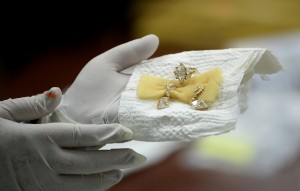 An official from the Presidential Commission on Good Government (PCGG) shows diamond jewellery seized by the Philippine government from former first lady Imelda Marcos, at the Central Bank headquarters in Manila on November 24, 2015. Philippine authorities on November 24 showcased a dazzling collection of jewels seized from the family of the late dictator Ferdinand Marcos appraised in preparation for a possible auction. The long-hidden collection, seized in three batches after Marcos was overthrown in 1986, also provides a stark look at how the Marcos family enriched itself while the nation sank deeper into poverty.     AFP PHOTO / NOEL CELIS / AFP / NOEL CELIS