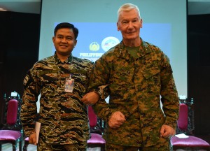 Philippine exercise director Vice-Admiral Alexander Lopez (L) and his US counterpart Lieutenant General John Toolan link arms during the opening ceremony of the annual joint 11-day Balikatan (Shoulder-to-Shoulder) military exercise in Manila on April 4, 2016. US and Philippine troops began major exercises on April 4 as China's state media warned "outsiders" against interfering in tense South China Sea territorial disputes.  / AFP / TED ALJIBE