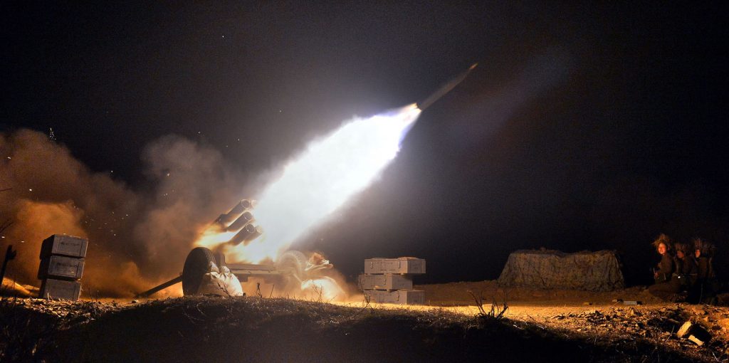 This undated photo released by North Korea's official Korean Central News Agency (KCNA) on April 12, 2016 shows a live-shell firing drill by artillery sub-units under large combined units of the North Korean Army, under the simulated conditions of beating back enemy forces conducting a surprise night landing. / AFP PHOTO / KCNA VIA KNS / KCNA