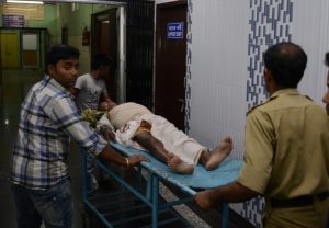 Indian staff at Siliguri Hospital help a victim injured during an earthquake in Siliguri on April 13, 2016. Myanmar was struck by a magnitude 6.9 quake on April 13, the US Geological Survey reported, with tremors in India and China sending residents rushing out into the streets.  / AFP PHOTO / DIPTENDU DUTTA