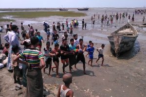 A handout photo taken on April 19, 2016 and released to AFP from anonymous Rohingya Muslim minority residents shows people carrying a dead body after a boat capsized off the coast in Sittwe. Witnesses to a boat capsize that left some 20 people dead, including children, say the victims were from the persecuted Rohingya Muslim minority and blamed the tragedy on restrictions that forced them to journey by sea. / AFP PHOTO / STR 