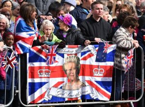 Wellwishers wait to see Britain's Queen Elizabeth II in Windsor as she celebrates her 90th birthday on April 21, 2016. Britain celebrated the 90th birthday of Queen Elizabeth II  with tributes to a popular monarch who has steered it through the decline of empire and a wave of scandals to the Internet age. / AFP PHOTO / BEN STANSALL