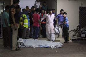 The bodies of two gay rights activists who were hacked to death are brought down from an apartment in Dhaka on April 25, 2016. Two leading gay rights activists were hacked to death on April 25 at an apartment in Bangladesh's capital, police said, the latest deadly attack on minorities in the Muslim-majority nation. Police did not identify the victims, but an official from Roopbaan, the country's only LBGT magazine, named one as editor and gay rights activist Xulhaz Mannan. / AFP PHOTO / Rehman Asad