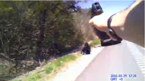 An Ohio police officer's body camera captures footage of him shooting a knife-wielding suspect on a highway near Cincinnati.(photo grabbed from Reuters video) 