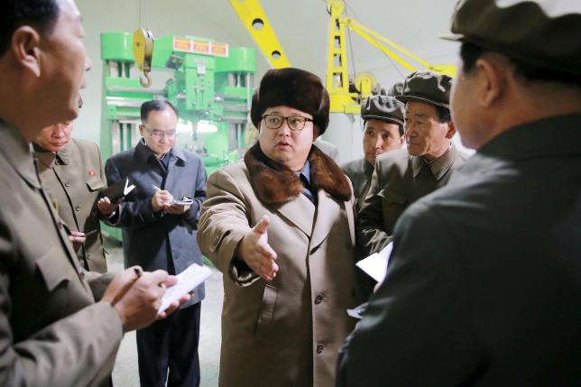 North Korean leader Kim Jong Un (C) speaks during a visit to the Sinhung Machine Plant in this undated photo released by North Korea's Korean Central News Agency (KCNA) in Pyongyang April 1, 2016. REUTERS/KCNA