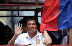 In this photo taken on March 2, 2016, shows Davao City Mayor and Presidential Candidate Rodrigo Duterte waves to his supporters during his campaign sortie in Lingayen, Pangasinan, north of Manila. Rodrigo Duterte curses the pope's mother and jokes about his own infidelities, but many voters in the Philippines want to elect him president so he can begin an unprecedented war on crime. / AFP PHOTO / NOEL CELIS