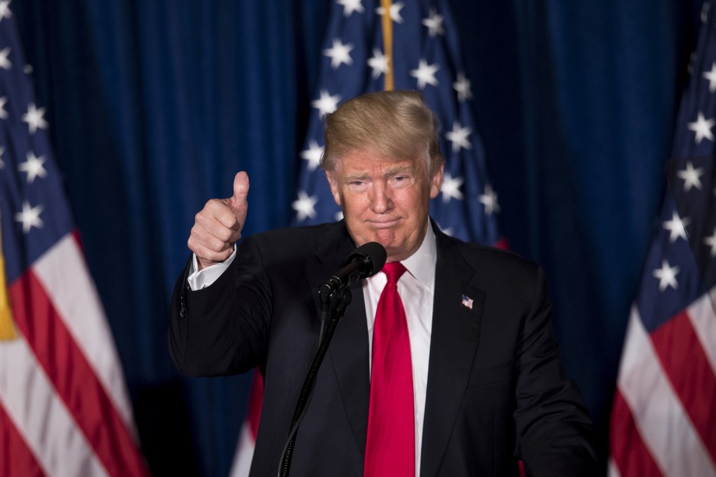 Republican presidential candidate Donald Trump gives a thumbs up after delivering a foreign policy speech at the Mayflower Hotel April 27, 2016 in Washington, DC. Donald Trump pledged Wednesday to pursue an "American First" foreign policy if elected president, demanding that allies contribute more to global security. "America First will be the major and overriding theme of my administration," he said in a speech outlining his foreign policy.  / AFP PHOTO / Brendan Smialowski