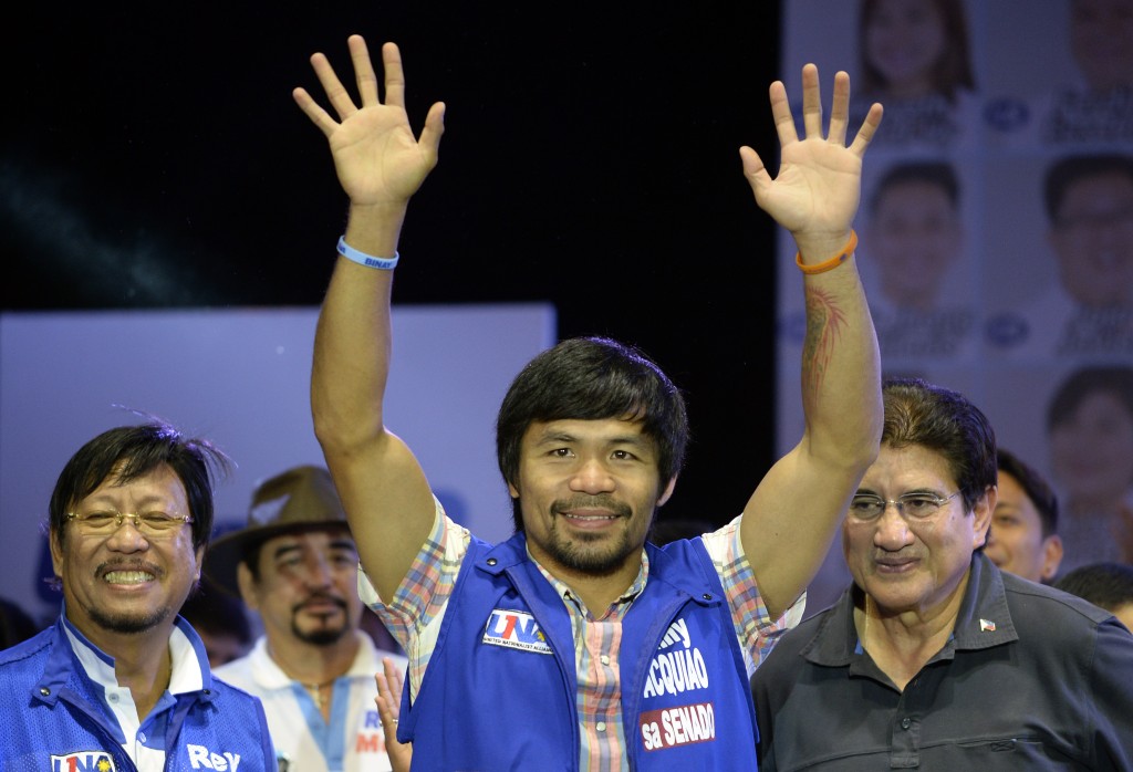 Philippine boxing champion and senatorial candidate Manny Pacquiao speaks onstage during presidential candidate and Vice President Jejomar Binay's Miting De Avance in Manila on May 7, 2016.  Philippine President Benigno Aquino warned May 7 the frontrunner in the race to replace him carried similar dangers to Hitler and would bring terror to the nation. / AFP PHOTO / NOEL CELIS