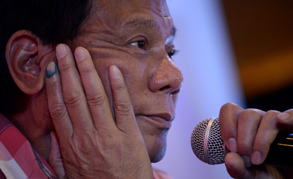 Presidential frontrunner and Davao City Mayor Rodrigo Duterte attends a press conference after he cast his vote in Davao City, on the southern island of Mindanao on May 9, 2016. Voting was underway in the Philippines on May 9 to elect a new president, with anti-establishment firebrand Rodrigo Duterte the shock favourite after an incendiary campaign in which he vowed to butcher criminals. / AFP PHOTO / NOEL CELIS