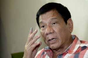 Philippines Presidential frontrunner and Davao City Mayor Rodrigo Duterte gestures as he is interviewed by reporters at a hotel in Davao City on the southern island of Mindanao on May 9, 2016.  Anti-establishment firebrand Rodrigo Duterte was heading for a huge win  in the Philippine presidential elections, according to a poll monitor, after an  incendiary campaign dominated by his profanity-laced threats to kill criminals. / AFP PHOTO / NOEL CELIS