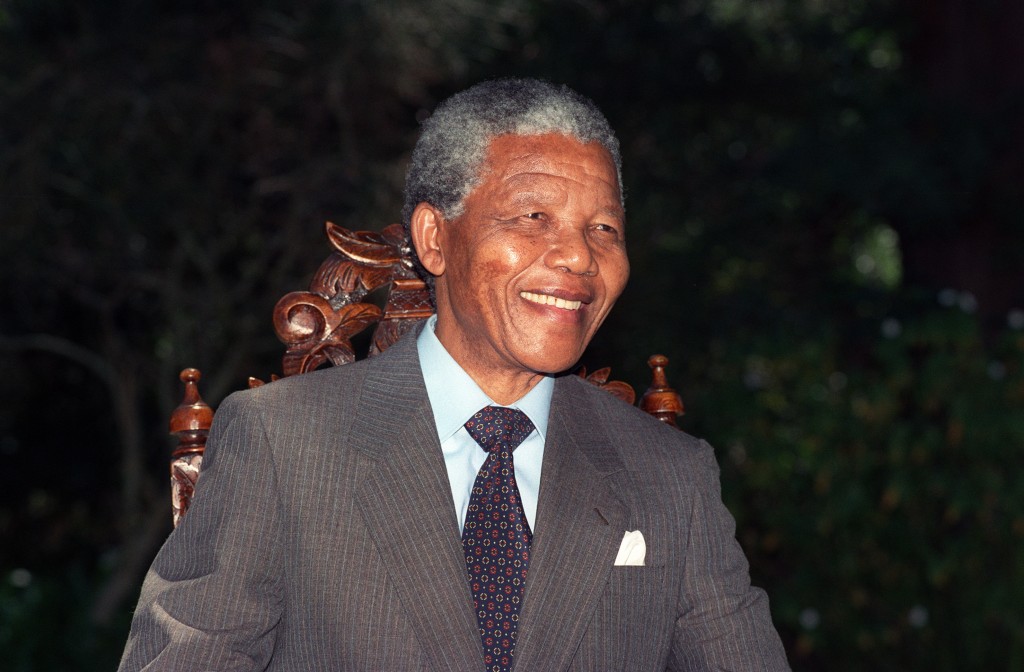 Anti-apartheid leader and African National Congress (ANC) member Nelson Mandela smiles during a photo session after his first press conference since his release from jail, 12 February 1990 in Cape Town. / AFP PHOTO / AFP FILES / WALTER DHLADHLA