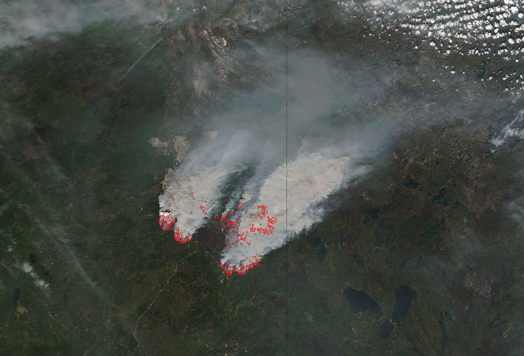 In this NASA satellite image obtained May 17, 2016, smoke from wildfires burning near Fort Mcmurray, Canada can be seen. Mandatory evacuation orders were issued for some 20 oil sands camps and facilities in Canada's Alberta province due to smoke and flames from the Fort McMurray wildfire, regional emergency officials said May 17, 2016. The evacuation orders, which affect some 8,000 people, were issued late Monday (0200 GMT Tuesday) for a region between Fort McMurray and a few kilometers south of the town of Fort MacKay, officials said.  / AFP PHOTO / NASA / HO / RESTRICTED TO EDITORIAL USE - MANDATORY CREDIT "AFP PHOTO / NASA" - NO MARKETING - NO ADVERTISING CAMPAIGNS - DISTRIBUTED AS A SERVICE TO CLIENTS