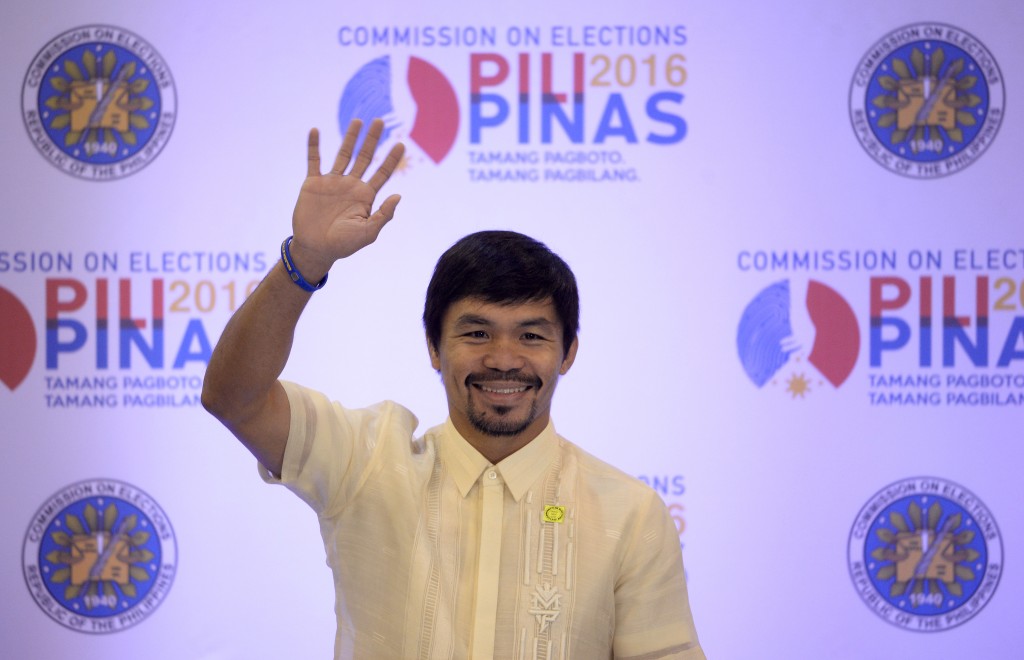 Philippine boxing icon and newly elected Senator Manny Pacquiao waves to reporters during a press conference after being proclaimed as senator by the Commission on Elections in Manila on May 19, 2016. Pacquiao, 37, whose rise from desperate street kid to boxing superstar has made him one of the nation's biggest heroes, retired from boxing last month to become a full-time politician. AFP PHOTO / NOEL CELIS / AFP PHOTO / NOEL CELIS