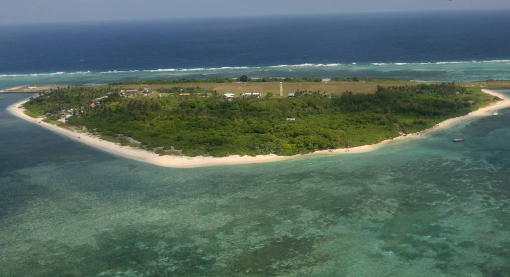 An aerial photo shows Thitu Island, part of the disputed Spratly group of islands, in the South China Sea located off the coast of western Philippines on July 20, 2011.  Philippine lawmakers flew to an island in the disputed Spratly chain, despite warnings from China that the trip would destabilise the region and damage ties.   AFP PHOTO / POOL / AFP PHOTO / POOL / ROLEX DELA PENA