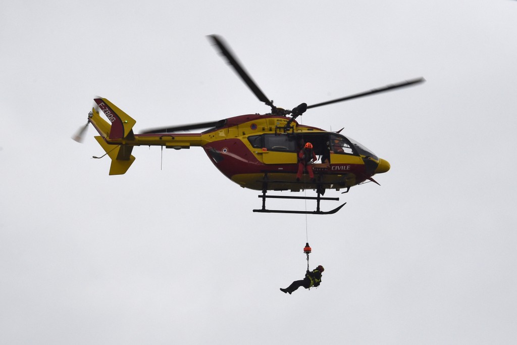 A rescuer is lifted back into a helicopter of the Securite Civile, France's civil defence agency, after assisting stranded residents following floods on June 1, 2016 in Nemours, southeast of Paris. Torrential downpours have lashed parts of northern Europe in recent days, leaving four dead in Germany, breaching the banks of the Seine in Paris and flooding rural roads and villages. AFP PHOTO / DOMINIQUE FAGET / AFP PHOTO / DOMINIQUE FAGET