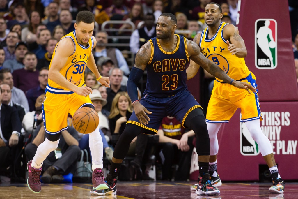 CLEVELAND, OH - JANUARY 18: Stephen Curry #30 drives down court after stealing from LeBron James #23 of the Cleveland Cavaliers while under pressure from Andre Iguodala #9 of the Golden State Warriors during the first half at Quicken Loans Arena on January 18, 2016 in Cleveland, Ohio. NOTE TO USER: User expressly acknowledges and agrees that, by downloading and/or using this photograph, user is consenting to the terms and conditions of the Getty Images License Agreement. Mandatory copyright notice.   Jason Miller/Getty Images/AFP