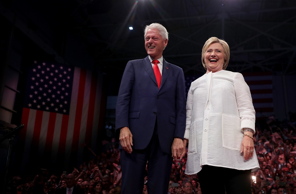 BROOKLYN, NY - JUNE 07: Democratic presidential candidate former Secretary of State Hillary Clinton (R) and her husband former U.S. president Bill Clinton greet supporters during a primary night event on June 7, 2016 in Brooklyn, New York. Hillary Clinton surpassed the number of delegates needed to become the democratic nominee over rival Bernie Sanders with a win in the New Jersey presidential primary   Justin Sullivan/Getty Images/AFP