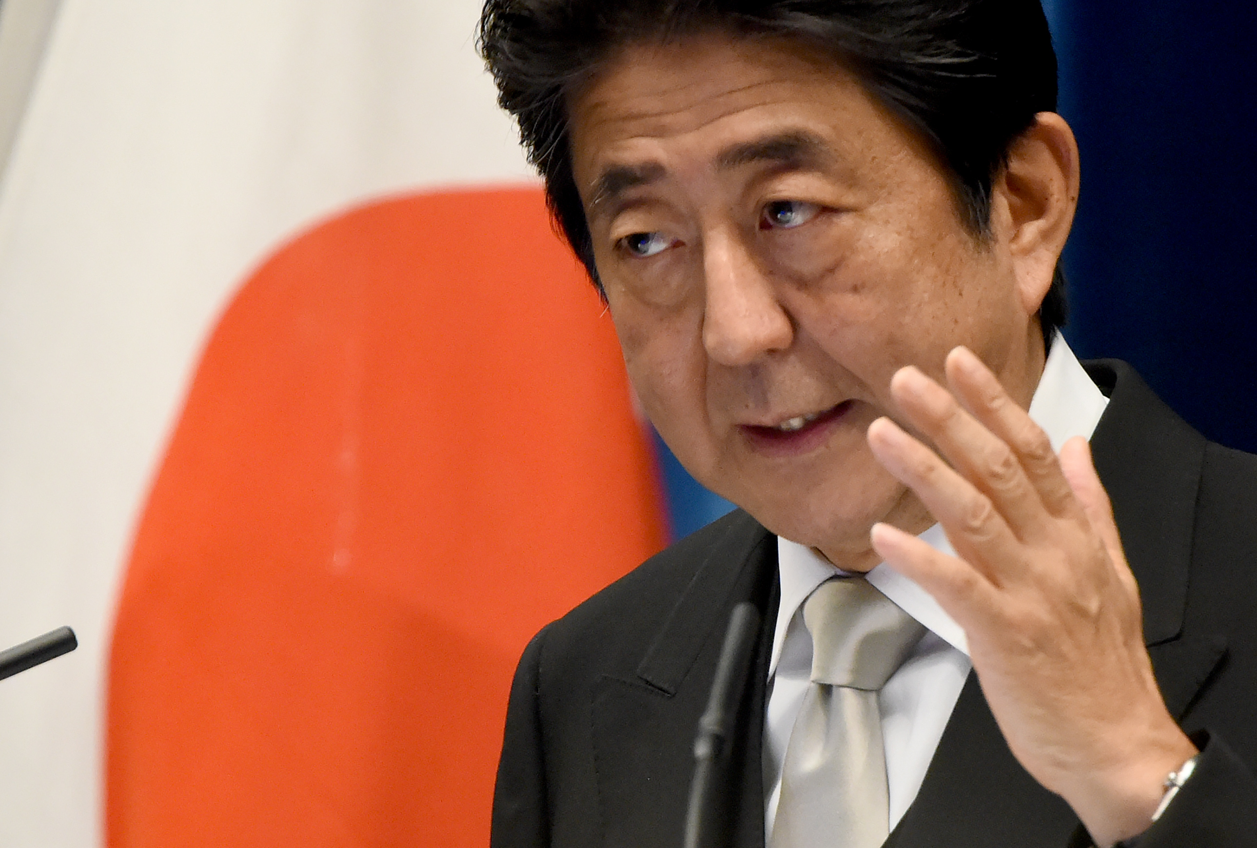 Japanese Prime Minister Shinzo Abe gestures as he answers questions during a press conference following the reshuffling of his cabinet, at Abe's official residence in Tokyo on August 3, 2016. Prime Minister Shinzo Abe on August 3 picked a close confidante with staunchly nationalist views as the new defence minister, a move likely to raise concerns in China and South Korea. / AFP PHOTO / TORU YAMANAKA