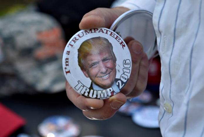 A man looks over campaign buttons before Republican U.S. vice presidential candidate Mike Pence speaks at a town hall at the Henderson Convention Center in Henderson, Nevada on August 17, 2016. REUTERS/David Becker