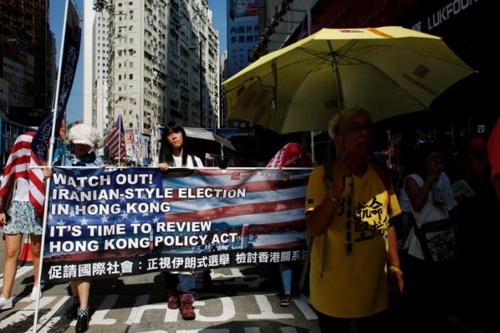 Protesters march against the government's disqualification of six candidates in the upcoming legislative election, on the grounds that they could be advocating for Hong Kong's independence, in Hong Kong, China August 21, 2016.   REUTERS/Bobby Yip