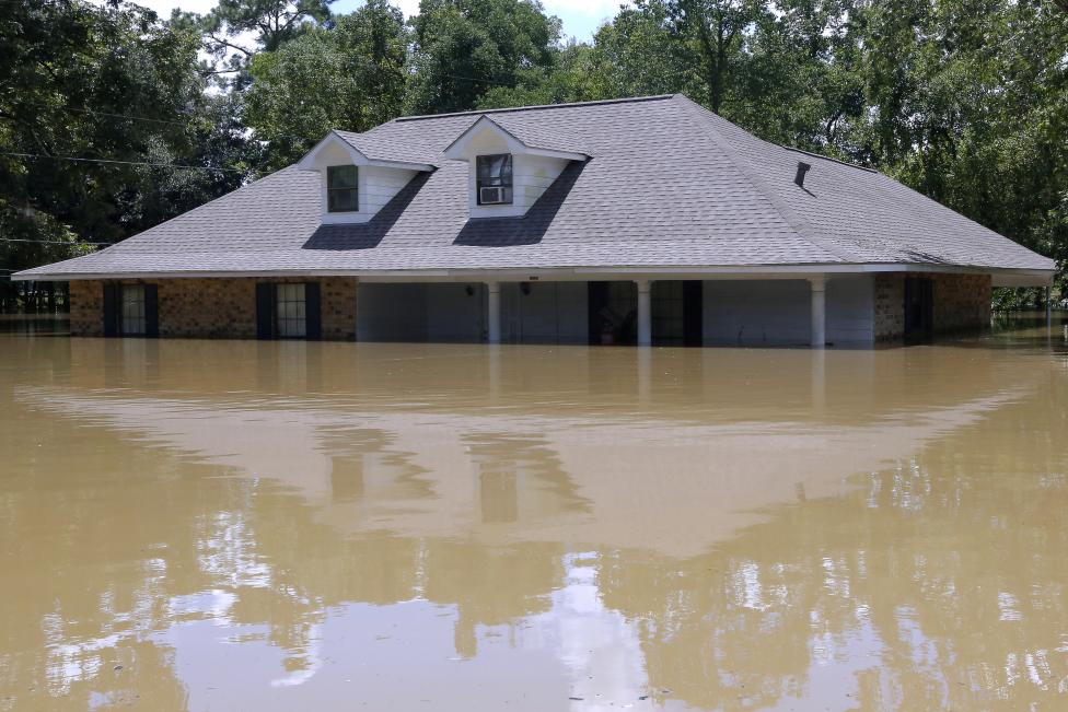 A submerged house is seen in Ascension Parish, Louisiana.  REUTERS/Jonathan Bachman